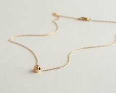 "Dainty minimalist handmade gold-filled or sterling silver necklace with a single tiny nugget, layered Fidget boho necklace. High-quality 14K gold-filled cube nugget on a delicate 14k gold-filled chain. This necklace is made from 14K gold filled. Unlike gold plating, the gold in gold-filled jewelry is mechanically bonded to the base metal, and it will not wear off or turn black. Achieve the \"sophisticated but cute\" look with this simply adorable gold-filled necklace! Wear it any day, every day Minimalist Tiny Beads Chain Necklace For Everyday, Minimalist 14k Gold-filled Charm Necklace With Delicate Chain, Yellow Gold Necklaces With Tiny Beads For Everyday, Minimalist 14k Gold Filled Chain Necklace As Gift, Minimalist Recycled Gold Pendant Charm Necklaces, Minimalist Tiny Charm Necklaces For Everyday, Gold Sterling Silver Necklace With Tiny Beads, Tiny Pendant Charm Necklace In Minimalist Style, Minimalist Pendant Charm Necklace