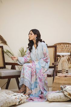 An Uber cool Ice blue ombré in-house printed raw silk shirt and dupatta. All feminine details of Pearls all over the shirt with hand-worked buttons. Our signature sleeve hem style is finished with pearl tassels and our in-house embroidered fabric. The daman is beautifully done with our appliquéd in-house embroidery. Printed dupatta in cool refined colors is finished off with laces and plain pants. Bohemian Silk Lawn Suit With Straight Kurta, Blue Bohemian Lawn Suit For Festive Occasion, Bohemian Blue Lawn Suit For Festive Occasions, Silk Long Sleeve Kurta With Digital Print, Summer Cotton Silk Long Sleeve Sets, Bohemian Unstitched Lawn Suit For Spring, Silk Kurta With Digital Print And Long Sleeves, Summer Anarkali Lawn Suit With Long Sleeves, Unstitched Bohemian Lawn Suit For Spring