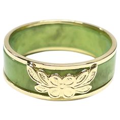 14 Karat Yellow Gold Green Jade Two-Part Ring. Two rings in one, a beautiful light sage green jade band and a yellow gold two band ring with a a four petal flower and leaves at the center. The ring measure 7mm wide and 2.4mm thick. The ring is size 8. The rings together weigh 4.06 grams. Luxury Green Engraved Men's Ring, Green Jade Jewelry, Gold And Jade Ring, Jade Engagement Ring Green, Jade Gold Ring, Jade Wedding Ring, Jade Engagement Ring, Four Petal Flower, Vintage Engagement Rings Simple