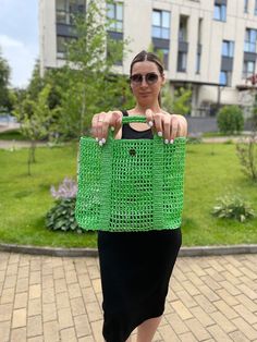 Introducing our stylish knitted summer bag, a perfect blend of elegance and practicality for young women and girls. This charming green bag is meticulously handcrafted using high-quality yarn, ensuring a durable and fashionable accessory that will complement any summer outfit. Designed with a short handle, this bag is ideal for casual outings, beach trips, or any occasion where you want to carry your essentials in style. The intricate crochet patterns create a beautiful texture, adding depth and Green Square Shoulder Bag For The Beach, Green Square Shoulder Bag For Beach, Green Square Beach Shoulder Bag, Green Square Shoulder Bag For Vacation, Summer Green Square Shoulder Bag, Summer Crochet Bag For Shopping, Trendy Green Crochet Bag For Vacation, Green Straw Bag For Spring Shopping, Green Crochet Bag For Daily Use In Spring