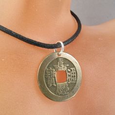 Antique CHINESE CHINA CASH COIN NECKLACE CHARM PENDANT -sterling silver jump ring -quantity 1 -your coin will come on a 24 inch adjustable black cord -you will receive the above coin -this is a genuine coin over two hundred years old and not a reproduction MORE COIN JEWELRY HERE http://www.etsy.com/shop/PartsForYou?section_id=7867468 AND MY OTHERSUPPLIES AND EARRING SHOP AT http://www.etsy.com/shop/CecileStewartJewelry?view_type=list Vintage Coin Pendant Jewelry For Good Luck, Nickel-free Round Pendant Coin Necklace In Amulet Style, Vintage Good Luck Coin Pendant Jewelry, Adjustable Medallion Coin Necklace Nickel Free, Adjustable Nickel-free Medallion Coin Necklace, Adjustable Coin Necklace, Braille Jewelry, Italy Necklace, Antique Coins