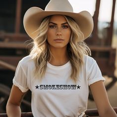 Smokeshow Graphic t-shirt for country girls and cowgirls is a Bella Canvas brand tee and comes in unisex cut and sizes. This graphic tee proudly proclaims you're a smokeshow and proud of it. Looks perfect alone or layered under a chic black blazer for a more sophisticated look. Whether she's an Oklahoma Smokeshow like the popular country song, or any smalltown smokeshow, she's worth celebrating. The perfect shirt for the rodeo, country music concert, a bachelorette party in Nashville or around t Summer Graphic Tee For Western-themed Events, Graphic Tee For Western-themed Spring Events, Spring Graphic Tee For Western-themed Events, Short Sleeve Tops For Western-themed Summer Events, Western Style Screen Print T-shirt For Western-themed Events, Graphic Tee For Western-themed Summer Events, Crew Neck T-shirt For Western-themed Spring Events, Western Pre-shrunk Tops For Summer, Western Style Cotton T-shirt For Country Concerts