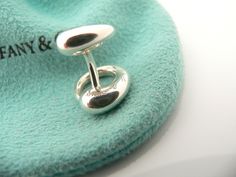 Overview: Offered for sale is a pair of very elegant and classic Tiffany and Co. Sterling Silver Eternal Circle Cuff Links. Super practical gift that will certainly be something that will be used often. Perfect surprise for that someone special! As always, the cuff links are fully hallmarked and guaranteed to be 100% authentic.Wonderful present for yourself or anyone you love! Will surely delight!It will come with its Tiffany pouch as shown! Perfect and ready for gifting! Particulars: Metal &amp Sterling Silver Cufflinks With Polished Finish, Luxury Sterling Silver Cufflinks For Gift, Designer Silver Cufflinks With Polished Finish, Silver Clip-on Cufflinks For Gift, Vintage Silver Screw Back Cufflinks, Tiffany And Co, Practical Gifts, Tiffany & Co., Cufflinks