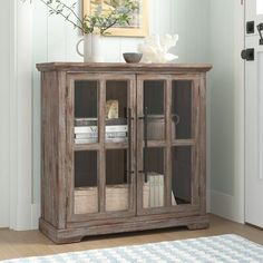 a wooden cabinet with glass doors in a room