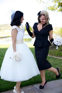 two women dressed in black and white are walking together