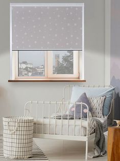 a white bed sitting under a window in a bedroom