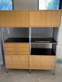 an office cabinet with four drawers and three shelves