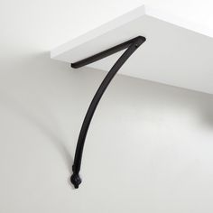 the corner of a white wall with a black handle