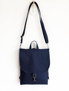 "Navy Blue Waterproof Backpack, Women's Vegan Bag, Water resistant Cross Body bag, Slim fit bag, Narrow Backpack Included in the price: - It also has a large inner pocket and carabiner closure, zippered interior pocket and plus two pockets. - Detachable and adjustable shoulder strap and backpack strap plus handle on the top. MATERIALS - outer: navy blue WATERPROOF fabric (100%PES) - internal: navy blue - nickel metal hardwer - navy blue thread If would you like this design but in a different col Blue School Backpack With Water Bottle Pocket, Blue Backpack With Anti-theft Pocket For Daily Use, Blue Everyday Bag With Water Bottle Pocket, Blue Backpack With Water Bottle Pocket For Daily Use, Blue Standard Backpack With Water Bottle Pocket, Blue Waterproof Backpack For Daily Use, Blue Backpack With Water Bottle Pocket, Waterproof Blue Standard Backpack, Blue Waterproof Standard Backpack