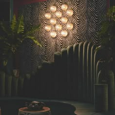 a black and white checkered floor in front of a wall with lights on it