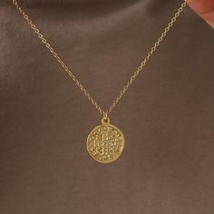 This gold pendant necklace features a medallion which says "Virtvte Tva Fiat Pax In" (“May there be peace in your strength") on the front. Enjoy two unique designs from front and back. Coin size: 18 mm, thickness: 1.5 mm Spring ring clasp 18K gold plated coin 14K gold filled chain Nickel-free Spiritual Tarnish-resistant Round Pendant Charm Necklace, Symbolic Gold Charm Necklace With Coin Pendant, Gold Charm Necklace With Coin Pendant Symbolic Style, Symbolic Tarnish Resistant Medallion Necklace, Gold Symbolic Coin Pendant Necklace, Symbolic Gold Coin Pendant Necklace, Symbolic Gold Plated Medallion Pendant Necklace, Spiritual Gold-plated Medallion Necklace With Round Pendant, Symbolic Gold Plated Coin Necklace