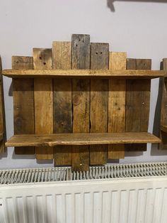 a wooden shelf sitting on top of a radiator