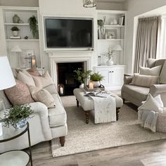 a living room filled with furniture and a flat screen tv mounted on the wall over a fireplace