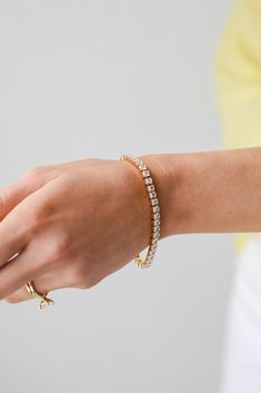 Elevate any look with the Gabi Gold Rhinestone Bracelet! This cute bracelet is made of a gold chain with rhinestones. Wear it on it's own or stacked with other bracelets, either way you'll love it! Gold Plated Rhinestones One Size | Diameter 2.5” + 2" Extender Gold Crystal Tennis Bracelet Bangle, Gold Crystal Tennis Bangle Bracelet, Gold Crystal Tennis Bracelet, Everyday Gold Crystal Jewelry, Dainty Gold Crystal Bracelets, Adjustable Gold Bracelet With Rhinestones, Dainty Gold Bracelets With Sparkling Stones, Dainty Gold Bracelet With Sparkling Stones, Gold Rhinestone Bracelets As Gift