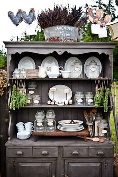 an old china cabinet is filled with dishes