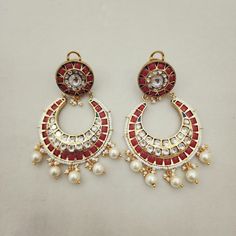 Adorn yourself with these Coral & Kundan Chandbali Earrings, crafted in gold foil. Featuring coral accents paired with Kundan work, these chandbalis blend traditional craftsmanship with timeless elegance. Perfect for special occasions, they add a regal touch to any ensemble. Length: 3" to 3.5" Material: 24Kt gold foil, lac Stones: Kundans, semi precious corals, semi precious pearls Traditional Chandbalis With Latkans For Celebrations, Temple Jewelry Chandbalis For Eid Festivities, Fusion Style Chandbalis With Latkans For Celebration, Fusion Hoop Earrings With Latkans For Celebration, Traditional Meenakari Hoop Earrings For Festive Occasions, Traditional Meenakari Hoop Earrings For Diwali, Gold Meenakari Chandbalis For Celebration, Fusion Style Festive Chandbalis With Cutdana Detail, Traditional Gold Chandbalis For Navratri