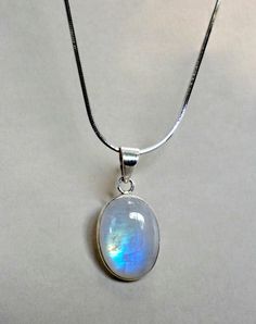 "This pendant necklace is made from 925 sterling silver and natural rainbow moonstone. Very beautiful and changing color according to a source of light! It looks fabulous and timeless :)  ♥ Please note as with all natural gemstones the color and inclusions may vary slightly from the pair shown. ♥ Each order will be gift wrapped beautifully ♥ QUALITY: Each item is stamped according to US regulations.  ➤ Orders of $550 and more will be qualified for free UPS International Express shipping (2-3 day Rainbow Moonstone Necklace, Rainbow Moonstone Pendant, Women Pendant, Blue Moonstone, Cabochon Pendant, June Birthstone, Natural Rainbow, Moonstone Necklace, Moonstone Jewelry