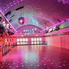 the inside of a building with lights and disco balls