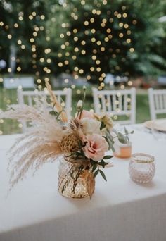 a table topped with a vase filled with flowers