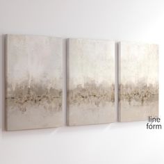 three abstract paintings hang on the wall