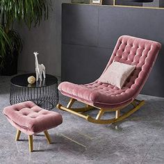 a pink chair and ottoman with a giraffe figurine in the background