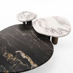 two marble tables sitting on top of each other