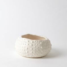 a white ceramic bowl sitting on top of a table