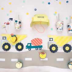 construction themed party decorations and cupcakes on a table with trucks, dump trucks and cars