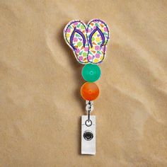 This Sea Shell Flip Flop Badge Reel is the perfect way to make a big splash at the office! Showing off your beach-loving personality with style, its beaded design and retractable, swiveling capabilities keep your ID or access badge just where you need it! Let your coworkers know you don't mess around when it comes to 'work-cessories'! Adjustable Multicolor Retractable Badge Reel, Adjustable Retractable Multicolor Badge Reel, Multicolor Retractable Badge Reel, Fun Multicolor Adjustable Badge Holders, Loving Personality, Big Splash, Trendy Accessories, Id Badge, Sea Shell