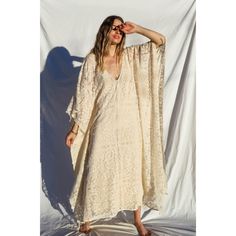 The Mykonos Kaftan is a piece that will elevate your style no matter how you wear it. This Kaftan features a v-neckline perfect for a flattering touch. The dual side-seam slits are oversized and so comfortable. The floral flourishes add a chic and romantic vibe, perfect for a candle-lit dinner under the stars. 100% Cotton Hand Wash Cold or Dry Clean Only V-neck Lined Maxi Dress For Daywear, V-neck Unlined Maxi Dress For Beach, Fitted V-neck Maxi Dress For Beach, Elegant V-neck Kaftan For Vacation, Unlined V-neck Maxi Dress For Beach, Summer V-neck Cover-up For Daywear, V-neck Maxi Dress Beach Cover-up, V-neck Maxi Dress For Beach Cover-up, Chic Beige V-neck Cover-up