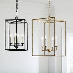 a chandelier with candles hanging from it's sides in a white room