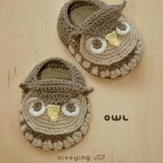 two crocheted baby shoes with an owl on them