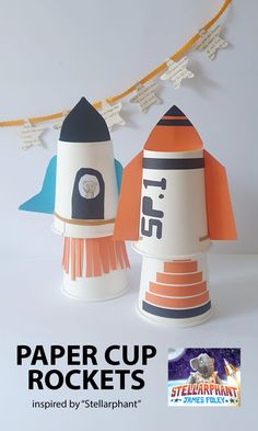 paper cup rockets are lined up in front of a banner that reads paper cup rockets