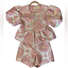 Never Worn, Still Has Tags On It! Purchased For $391 For A Wedding Event And Didn’t End Up Wearing It Bc It Was Too Cold Outside! Absolutely Adorable Two Piece Set! Top Has Puff Sleeves And Bow Buttons With Rhinestones! Set Is A Light Pink With Pink Florals And Gold Shimmer Accents! Both Top And Shorts Are An Xs. Summer Silk Sets With Short Sleeves, Feminine Silk Sets For Summer, Pink Silk Evening Set, Fitted Pink Set For Summer, Feminine Silk Sets For Spring, Pink Silk Sets For Spring, Chic Fitted Pink Sets, Feminine Fitted Silk Set, Fitted Silk Feminine Set