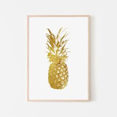 a gold pineapple print hanging on a wall