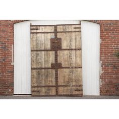 an old wooden door in front of a brick wall