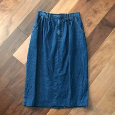 "This 1980s Vivaldi Jeanswear is absolutely awesome. Constructed from 100% cotton, this quintessentially 80s denim skirt looks like it was hardly ever worn! The skirt features a flat waistband, slanted pockets, soft pleats accentuated by double belt loops on the front of the skirt, and a 9-inch slit on the center back of the hemline. The skirt closes with a metal snap and a snap and a 7-inch metal zipper. The skirt still has its original faux leather belt with silver tones metal hardware. The sk Denim Skirt Looks, 80s Denim Skirt, Double Belt, 80s Denim, Faux Leather Belts, Wool Trousers, Metal Zipper, Metal Hardware, Leather Belt