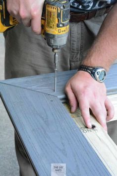 a man is using a drill to cut plywood planks with a power drill