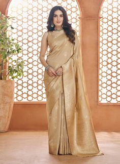 This elegant designer cream saree for women is perfect for any special occasion. Its Banarasi silk fabric adds a touch of luxury, while the intricate design adds a traditional charm. Complete with a matching blouse, this saree is the perfect choice for weddings, bridesmaids, and sangeet or reception wear. A beautiful gift for yourself or a loved one. The unstitched blouse can be customized upto 44 inches. Do Note: All the accessories shown are for styling purpose only. Slight color variation may Saree For Women Indian, Cream Saree, Banarasi Sari, Reception Saree, Peach Saree, Indian Party, Indian Party Wear, Saree For Women, Banarasi Silk Saree