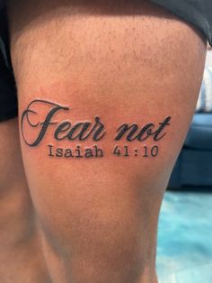 a man's leg with the word fear not written in black ink on it