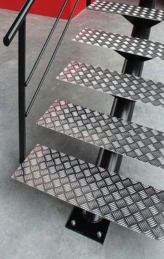 a set of three metal steps sitting next to each other