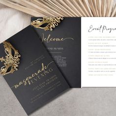 an elegant black and gold wedding suite with matching brochure is displayed on a table