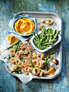 a tray filled with green beans and shrimp