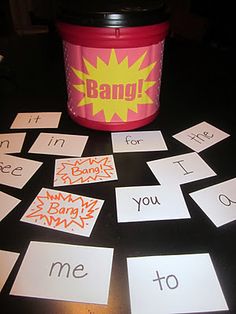 a table topped with lots of cards next to a bucket filled with writing and words