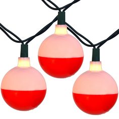 three red and white christmas balls hanging from string lights