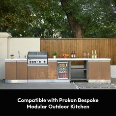 an outdoor kitchen with wooden cabinets and stainless steel appliances