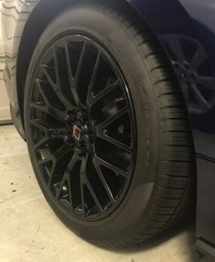 the front wheel and tire of a blue car