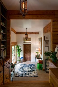 an entry way with a rug and potted plants