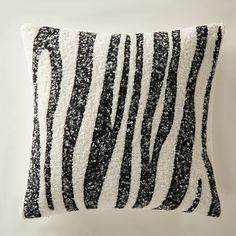 a black and white pillow on a white background with zebra print in the middle,