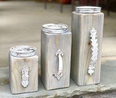 three canisters sitting on the ground next to each other